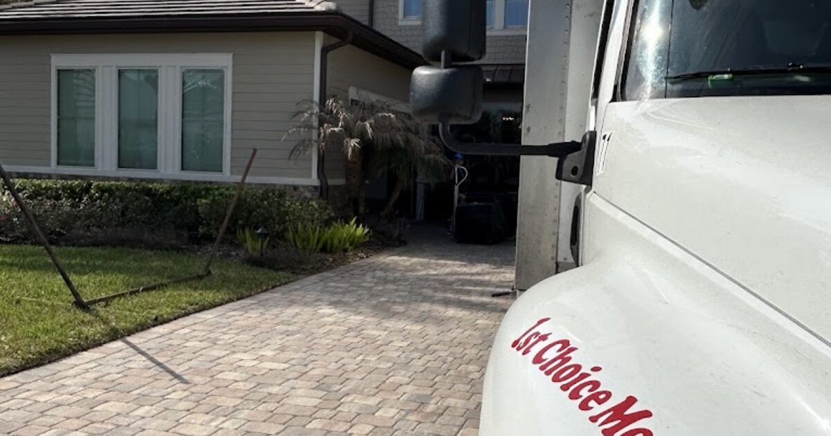 1st Choice Movers truck parked on a paved driveway outside a home