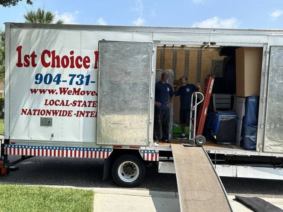 1st Choice Movers crew beside a loaded truck with its ramp down