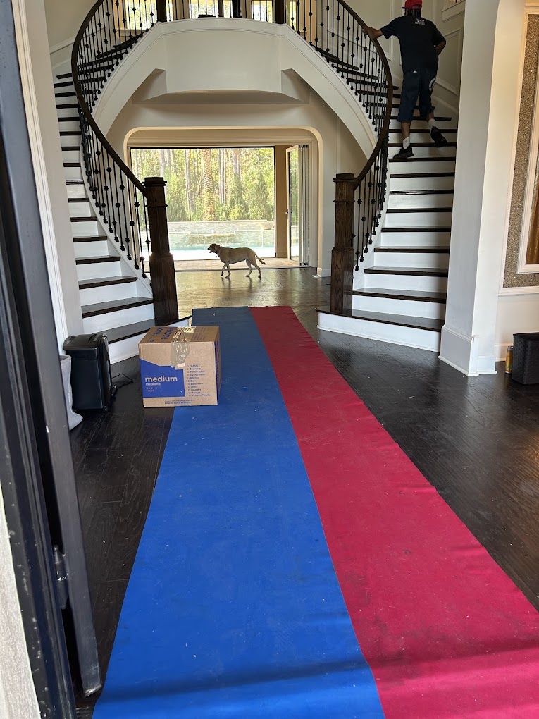 Floor runners protecting hardwood floors and stairs during a move
