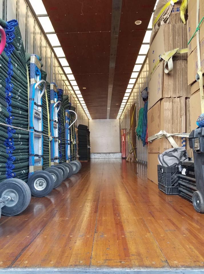 Moving truck stocked with dollies, blankets, boxes, and professional moving equipment