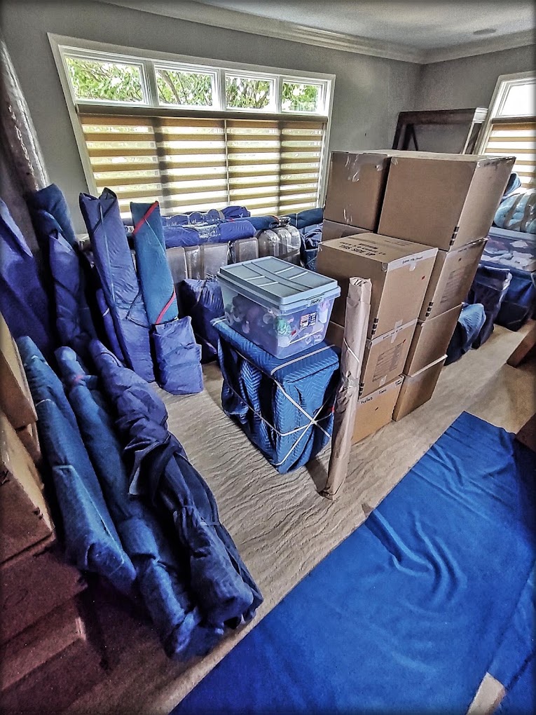 Furniture, boxes, and household items protected with moving blankets